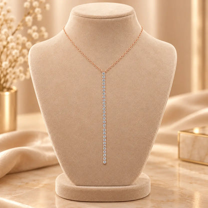 Rose gold tone moissanite drop necklace with a delicate vertical stone design