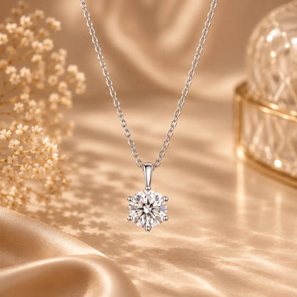 Round cut moissanite pendant necklace styled in an elegant warm beige setting