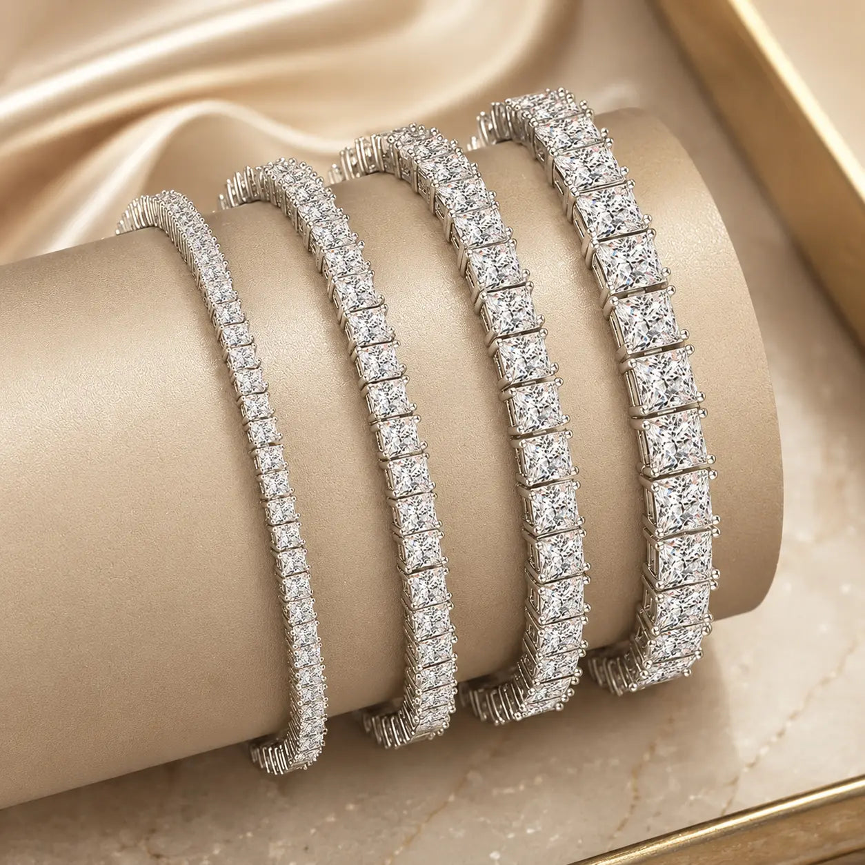 Round moissanite tennis bracelets for women shown in multiple stone widths and sizes on a luxury beige display.
