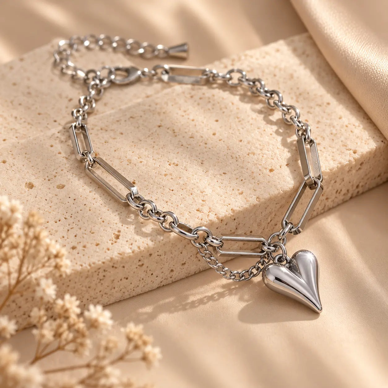 Silver tone heart charm bracelet with mixed link chain details