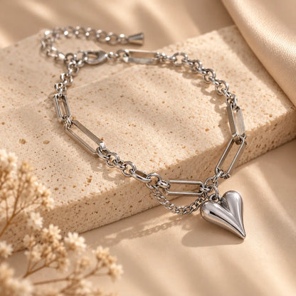 Silver tone heart charm bracelet with mixed link chain details