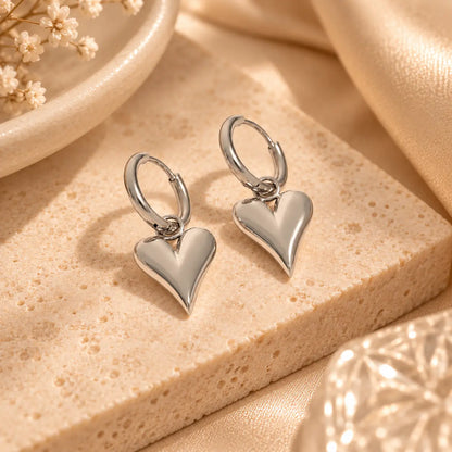 Silver heart hoop earrings with polished dangling heart charms