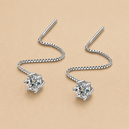 silver moissanite threader earrings close up on beige background