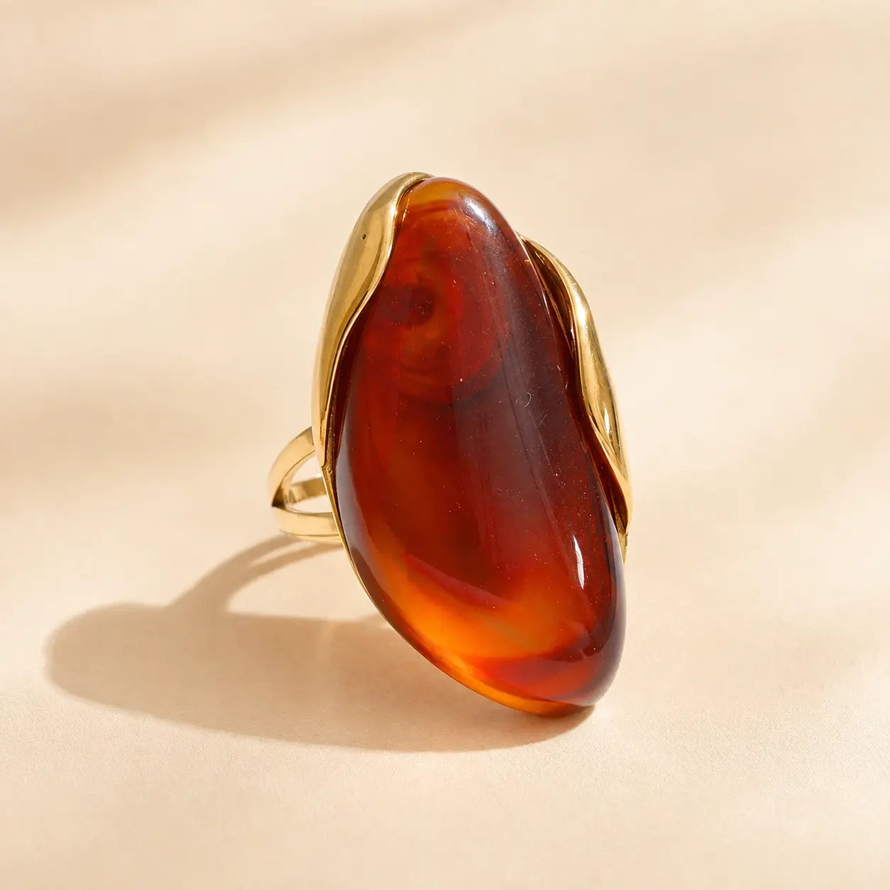 Amber brown Solenne™ resin statement ring for women with a rich translucent look and refined gold-tone details.