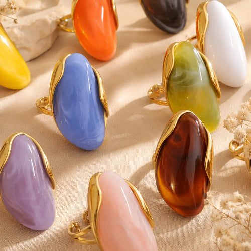 Solenne™ Color Resin Statement Ring for Women shown in multiple vibrant colors with polished gold-tone stainless steel details.