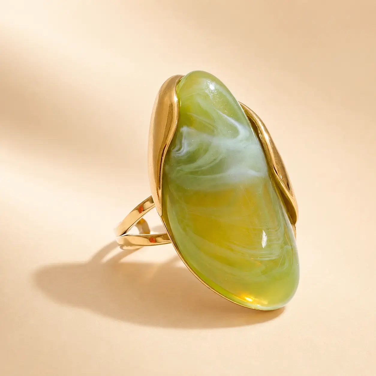 Green Solenne™ resin statement ring for women featuring a glossy sculptural design and polished gold-tone setting.