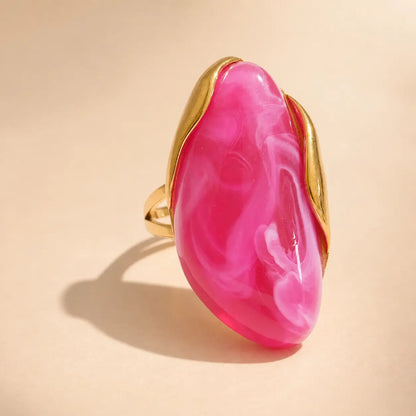 Hot pink Solenne™ resin statement ring for women designed with a bold glossy finish and refined gold-tone detailing.