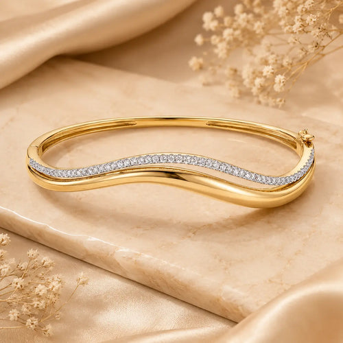 Wave moissanite bangle bracelet for women featuring a polished gold-tone finish and a sparkling curved stone row.